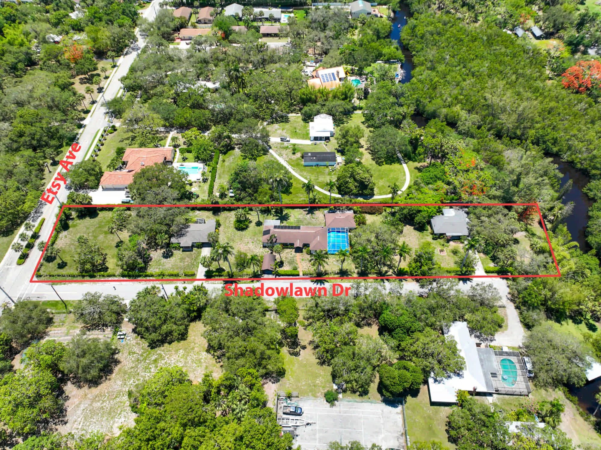 Rectangular property in Naples, FL, outlined in red for TN Capital Investments, with houses, pool, East Ave/Shadowlawn Drive, and greenery.