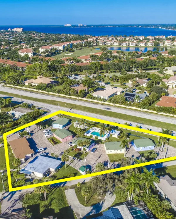 Aerial view of TN Capital Investments property outlined in yellow in Naples, FL, with houses, pool, palm trees, and nearby water.